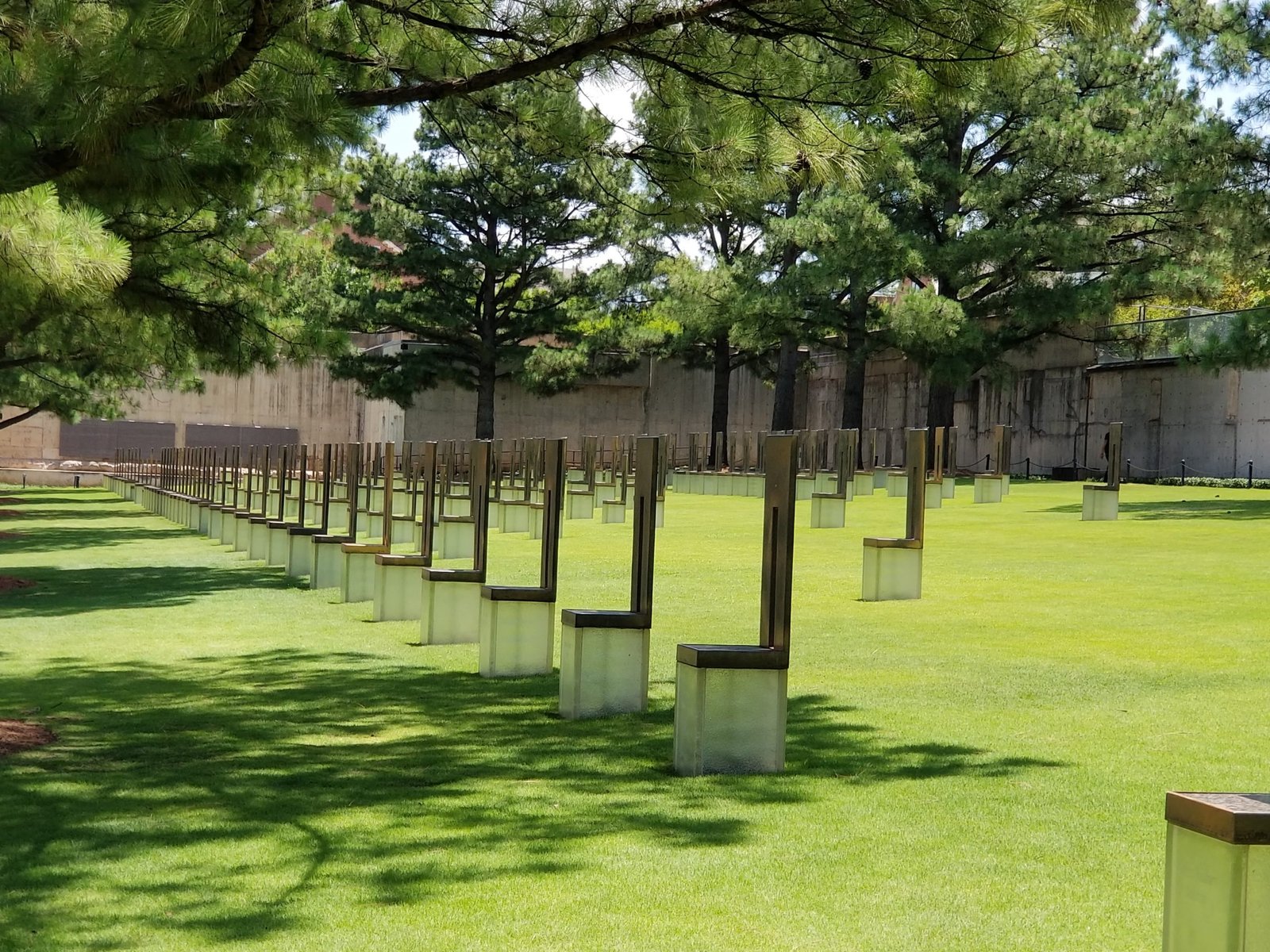 The 168 Chairs represent those killed on April 19, 1995. They stand in nine rows, each representing a floor of the Federal Building where the field is now located. Each chair bears the name of someone killed on that floor. Nineteen smaller chairs stand for the children.
..........................................